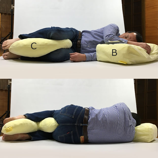 【使用例】90度側臥位を真横から見ています。クッションを下肢の間に挟んで下肢が平行に見えるように整えましょう。下肢の内側の除圧と股関節の中間位保持が目的です。